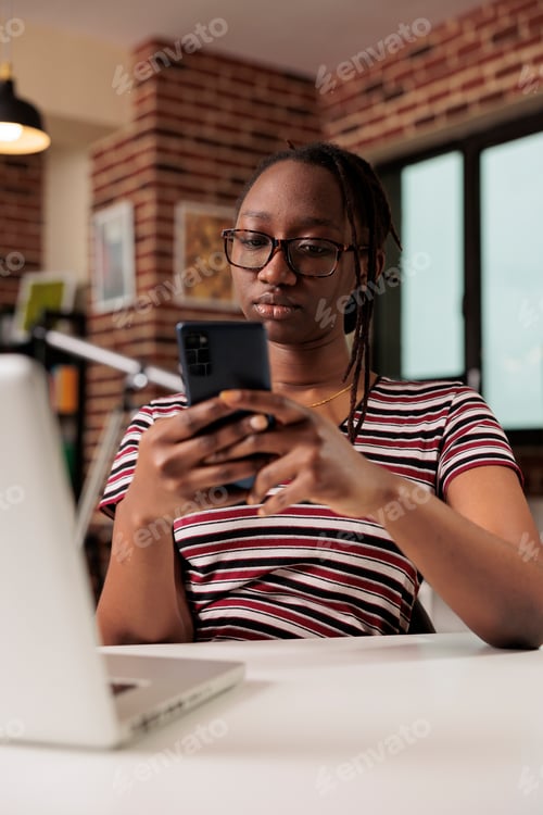 Preview: Freelancer sending text messages on smartphone