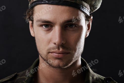 Preview: Stern soldier. Shot of a young man in military fatigues.
