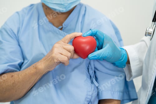 Preview: Doctor give red heart to Asian senior or elderly old lady woman patient, healthy strong medical