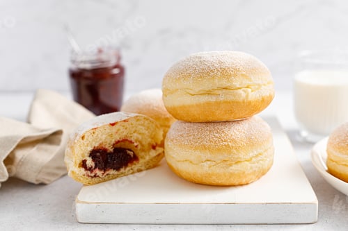 Preview: Berliner donut. Traditional german donut with raspberry jam, dusted with icing sugar