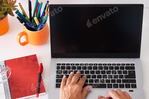 Preview: Female hands typing on keyboard using laptop computer in a modern minimalist workspace