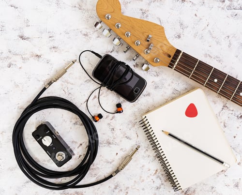 Preview: Music stuff. Guitar, guitar pedal, headphone, mobile phone on white background. Top view. Flat lay