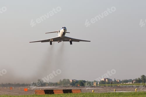 Preview: Airplane take off from military airfield. Smoke from engines, low over the runway.
