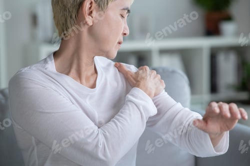 Preview: Asian senior woman suffering from shoulder pain.