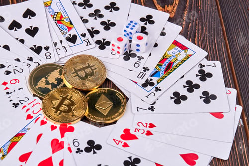 Preview: Close-up bitcoins with cards and dices on wooden desk