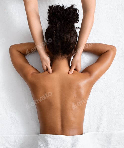 Preview: Female therapist massaging black woman neck, top view