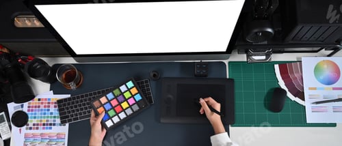 Preview: Female designer working modern computer and graphic tablet in creative office.