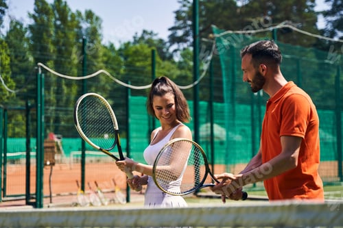 Preview: Instructor showing a proper tennis grip technique to his client