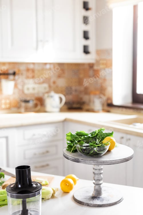 Preview: Fresh organic vegetables and lemons are on the table in the kitchen. Ingredients for making a green