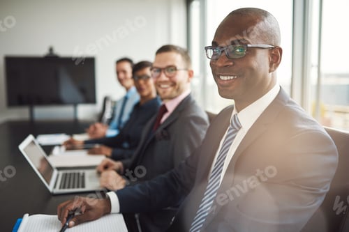 Preview: Smiling confident African businessman in a meeting