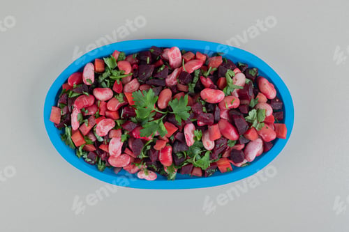 Preview: A blue wooden plate full of delicious vinaigrette