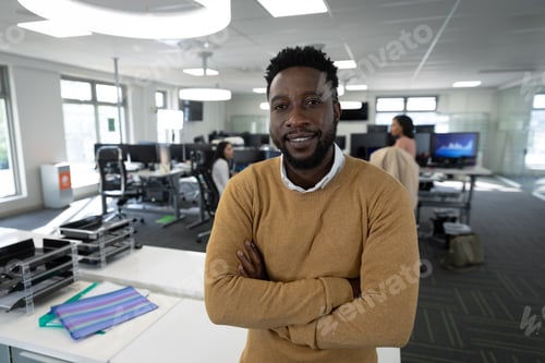Preview: Portrait of Businessman with arms crossed at modern office