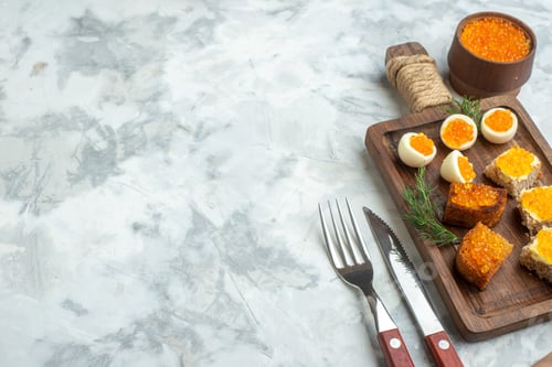 Preview: front view delicious caviar sandwiches with boiled eggs on cutting board white surface breakfast