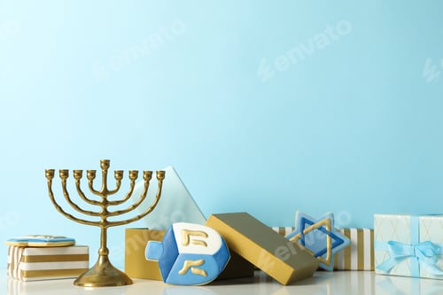 Preview: Hanukkiah, gift boxes and gingerbread cookies on blue background, space for text