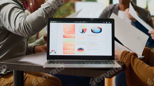 Preview: Multiethnic group of coworkers analyzing business charts