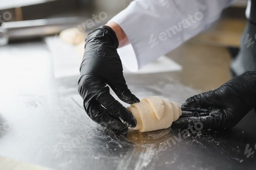 Preview: Baker making croissant dough in bakery kitchen