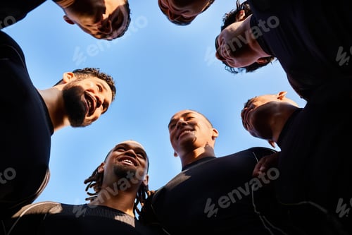 Preview: Low angle shot of a diverse group of sportsmen huddled together before playing a game of rugby