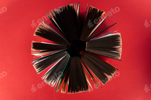 Preview: Top view of hardcover books on red surface