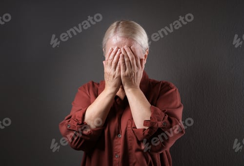 Preview: Mature woman suffering from depression on grey background