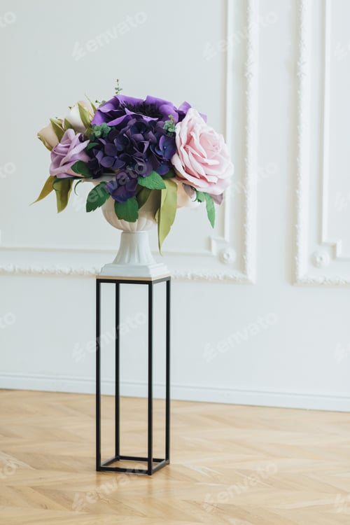 Preview: beautiful magnificent flowers of roses in white vase on stand against white background