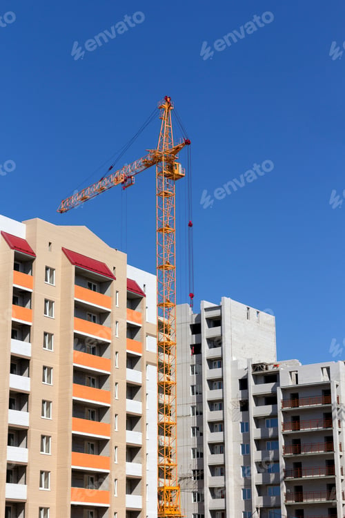 Preview: Industrial landscape, building crane against the blue sky