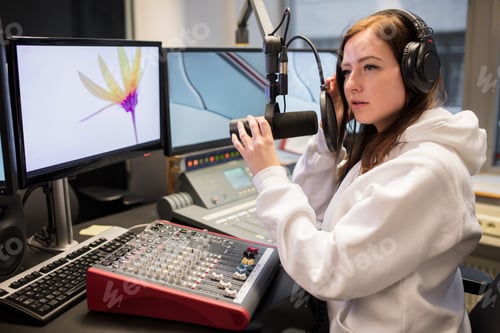 Preview: Host Adjusting Headphones And Microphone At Table In Radio Studi