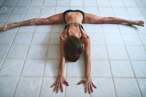 Preview: Full length shot of an attractive young female athlete working out at home