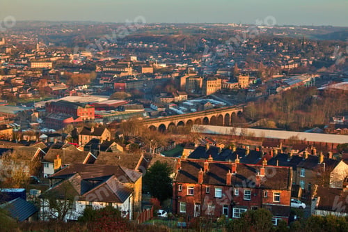 Preview: Aerial shot of a small town in England with old buildings under the blue sky