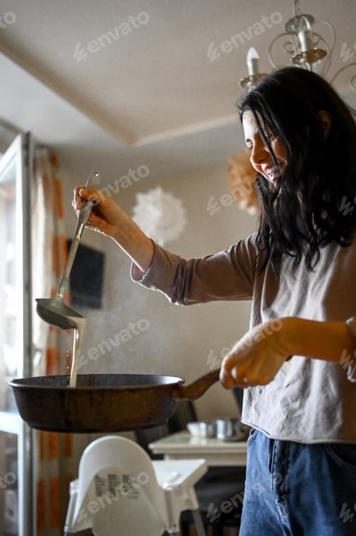 Preview: Mom bake pancakes at home in the kitchen