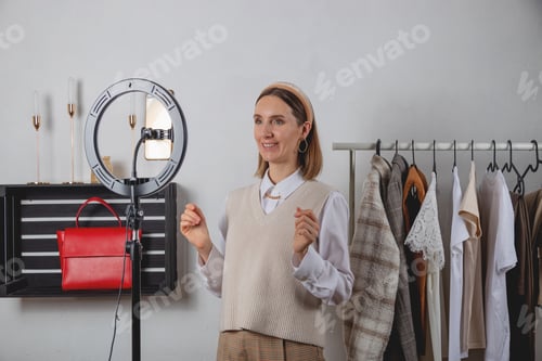 Preview: Woman millennial fashion stylist records fashion video on smartphone