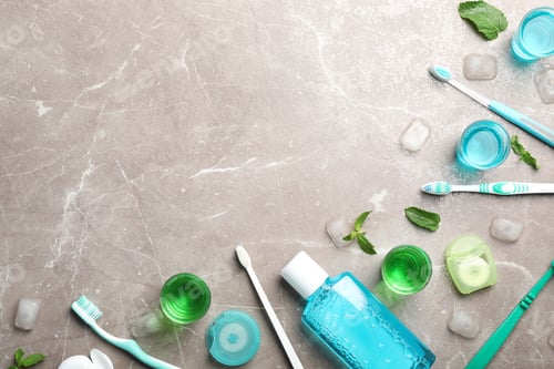 Preview: Flat lay composition with oral care products and space for text on marble background. Teeth hygiene