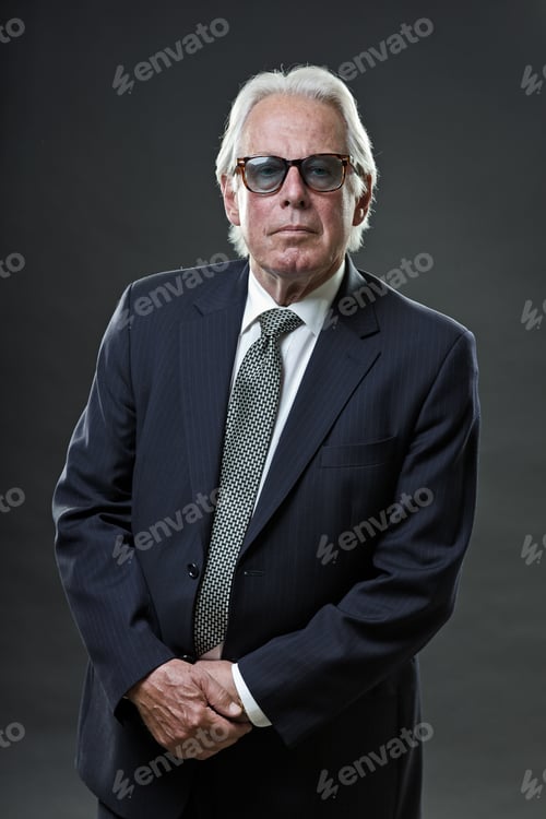 Preview: Studio Portrait Of Senior Business Man With Sunglasses Looking Confident.