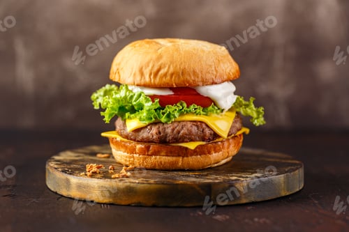 Preview: Close-up of home made tasty burger on wooden table.