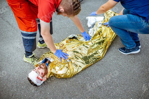 Preview: Medic covering victim with thermal blanket after the accident