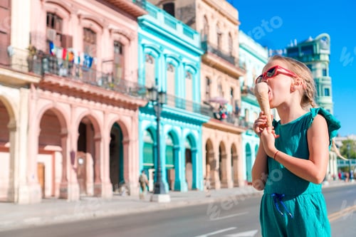 Preview: Adorable little girl eating ice-cream in popular area in Old Havana, Cuba. Portrait of cutiest kid