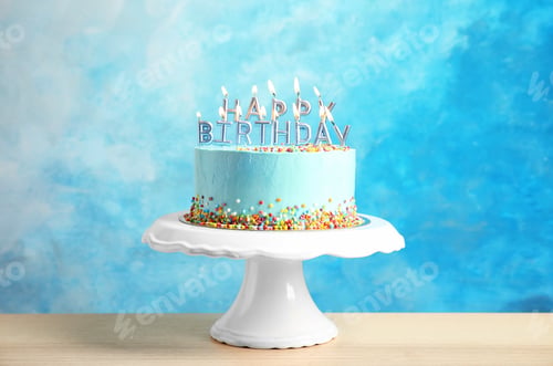 Preview: Fresh delicious birthday cake with candles on stand against color background