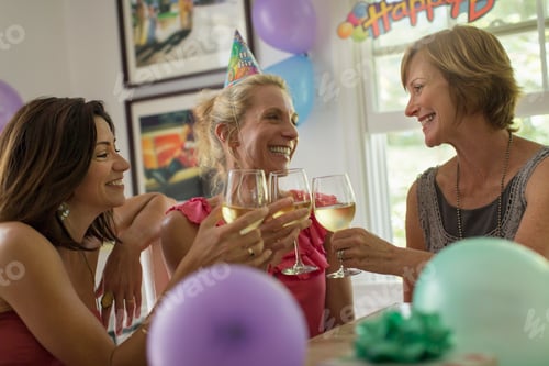 Preview: Three mature women toasting with wine glasses