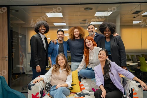 Preview: Multicultural team posing cheerfully in an office.