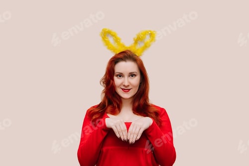 Preview: Woman Wearing Bunny Ears Smiling in Studio Setting