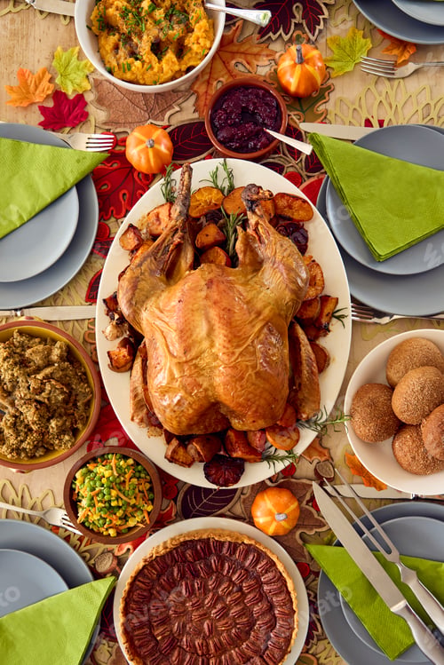 Preview: Overhead Shot Of Table Set For Thanksgiving Meal With Turkey And Pumpkin Pie Topped With Pecans