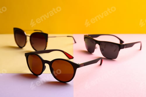 Preview: Stylish sunglasses on color background. Summer time