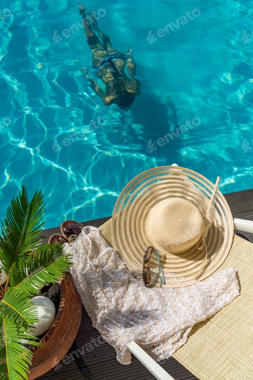 Preview: woman in luxury spa resort near the swimming pool.