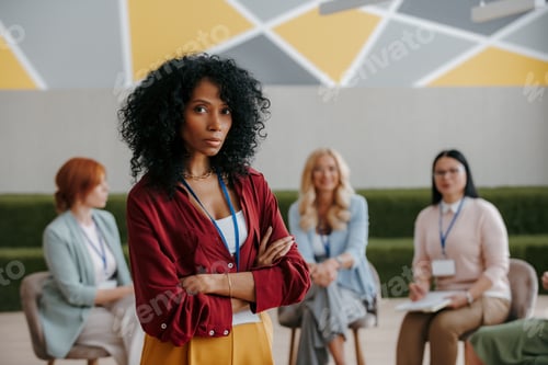 Preview: Confident African woman looking at camera while visiting group training class for females