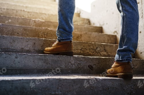 Preview: Close up of man walking up on concrete staircase