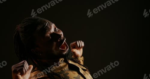 Preview: Lazy male model feeling sleepy on black background