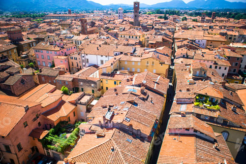 Preview: Beautiful view of ancient old buildings with red roofs background mountains in Lucca, Italy