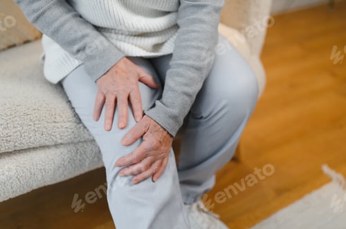 Preview: Chronic arthritis. Senior woman suffering from pain in knee at home