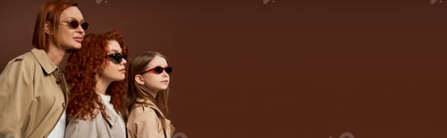 Preview: three female generations with red hair posing in sunglasses and coats on brown backdrop, banner