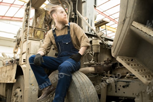 Preview: Repairman Resting On Truck