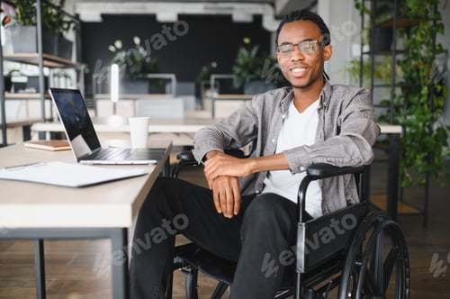 Preview: African american student in wheelchair studying at modern workspace